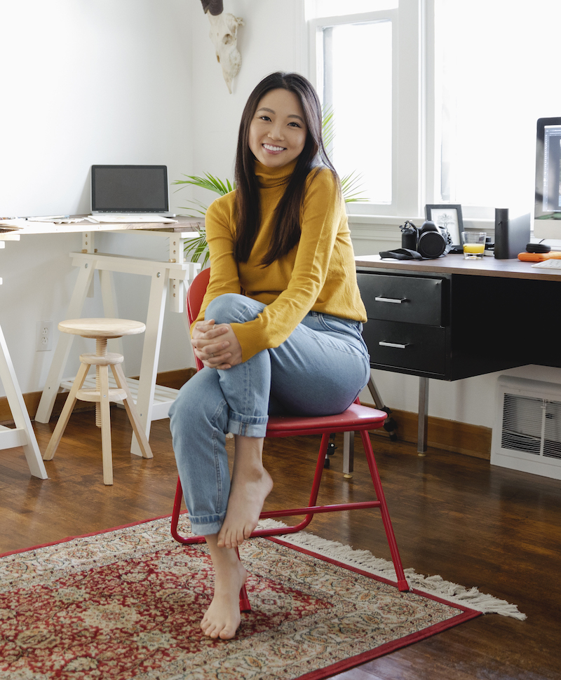 female assurant employee sitting and smiling at camera