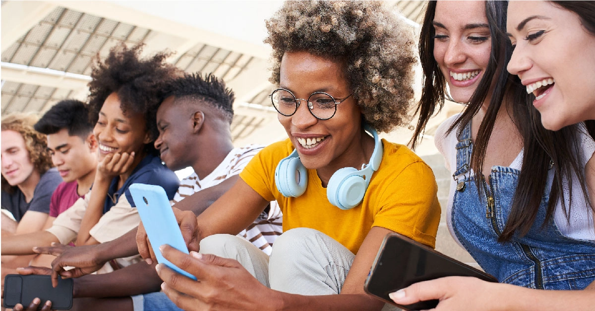 a group of people looking at a tablet